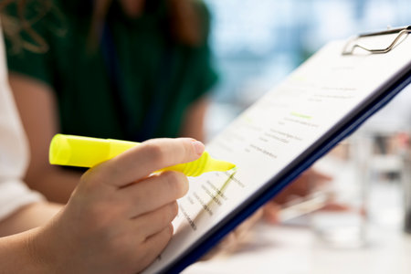 HR expert negotiating job offers and salary packages with candidate, highlighting text on document....