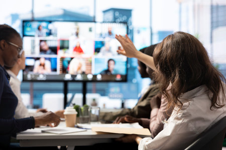 Diverse team of workers reviewing project updates together with shareholders on video call online meeting, ensuring easy remote collaboration for global business expansion plans. Teamwork.の写真素材