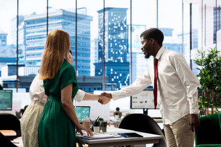 HR worker in economic sector startup checking if job candidate qualifications are aligned with company demands. Stock market business recruiter shaking hands, agreeing terms with applicantの写真素材