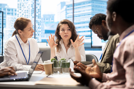 During a briefing meeting, general manager and his work team discussing budget forecasts and making financial projections to achieve enterprise goals. Analyzing market trends.の写真素材
