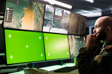 Counterterrorism division operative using target acquisition tech on mockup monitors to detect enemy location. Defense security expert using green screen satellite hardware to track threatsの写真素材