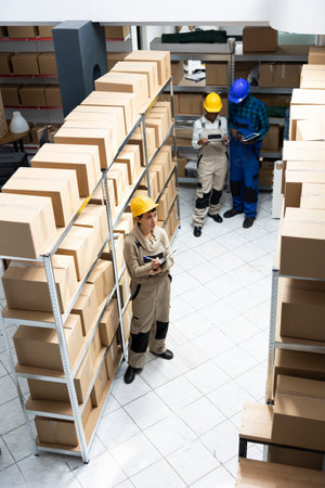 Industrial workspace supporting supply chain process to organize boxes and prepare shipments for dispatch in a highly functional logistics center. Quality control in cargo depot.の写真素材