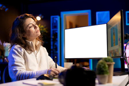 Photographer uses photo editing software on mockup PC display in personal studio. Freelancer uses photographs retouching program on isolated screen multi monitor computer setupの写真素材