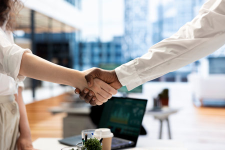 Businessmen in office shaking hands after finishing lucrative financial agreement for company. Close up of manager meeting with man, doing welcoming handshake gesture before starting conversationの写真素材