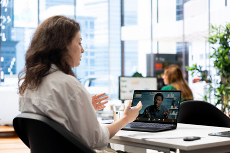 HR expert negotiating job offers and salary packages with candidate during videocall chat. Recruiter analyzing applicant resume and cover letter, doing teleconference meetingの写真素材