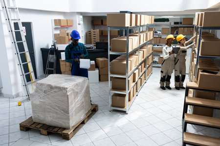 Diverse employees group preparing parcels and managing stock in an organized warehouse depot...