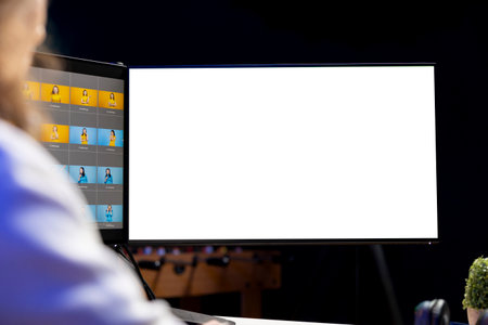Photographer using photo editing software on mockup multi monitors setup to improve images quality. Photo editor utilizing pictures retouching application on isolated screen displayの写真素材