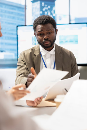 Chief executive officer leads a corporate briefing in boardroom, reviewing economic forecasts and discussing enterprise solutions. Experts setting strategic objectives for the upcoming plan.の写真素材