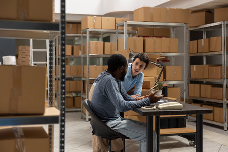 Small business depot captures product handling and delivery service operations within a warehouse full of inventory, diverse workers managing orders and shipping logistics. Distribution.の写真素材