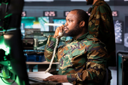 Intelligence officer using communication systems to call in air strikes on enemy troops. Military dispatcher making telephone call to request air support for ground soldiersの写真素材