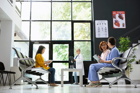 Female nurse explains medical tests and recovery steps to an asian patient, doing referrals and treatment recommendations. Healthcare provider examines medical history, wellness.の写真素材