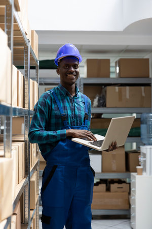 African american man staff managing order shipment with boxes and products for e commerce...