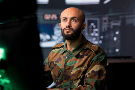 Air defense command professional using radar infrastructure to detect incoming ballistic missiles. Military soldier in base of operations scanning rockets approaching country, deploying shieldsの写真素材