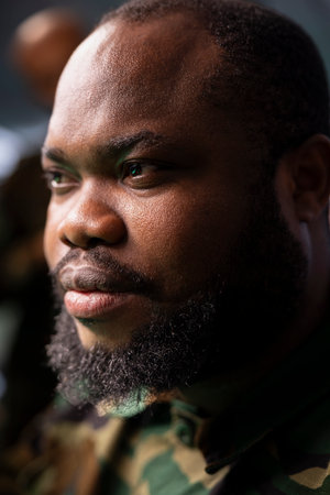 Air force combat control officer performing tactical level surveillance in command center. Headshot close up of military professional using radar systems to look at potential assault zonesの写真素材