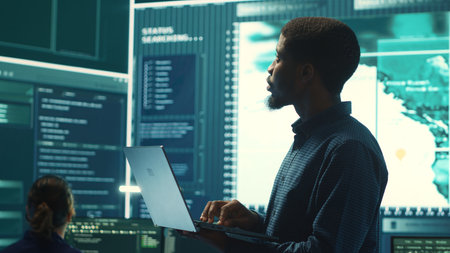 Cyber security team investigates governmental hacking malware attack on internet servers, high tech office. Cybercriminals hack computer systems, threatening account database protection. Camera A.の写真素材