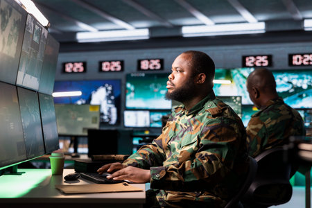 Soldier in war room analyzing aerial reconnaissance data to come up with warfare winning tactics....