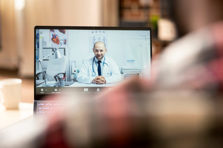 African american entrepreneur has online meeting with caucasian doctor, exchanging ideas on medical projects while working from home. Remote healthcare consultation on laptop.の写真素材