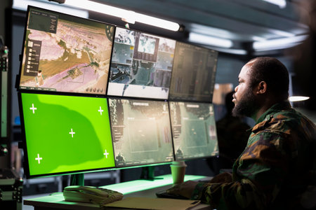 Soldier analyzing aerial reconnaissance data on green screen devices to come up with warfare winning...