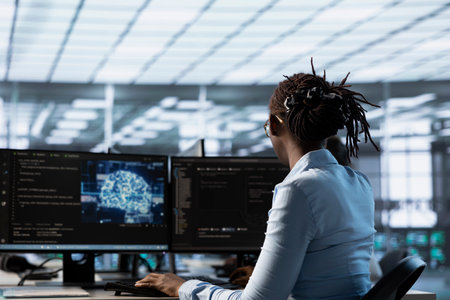 System admin programming in AI data center housing advanced equipment used for machine learning...