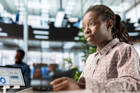 African american manager analyzing company data for strategic planning, solving resource allocation and effective business operations. Expert does financial forecasting and data analysis.の写真素材