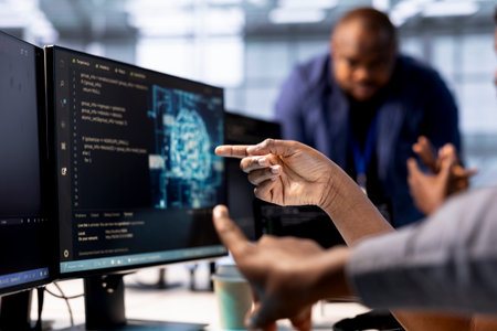 Server farm admin showing colleague AI technology on computer, creating and implementing algorithms....
