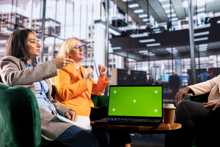Entrepreneurs team with a success story work next to green screen, using professional devices and...