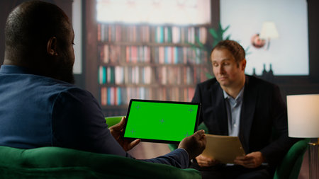 Team of skilled agents engaging in a strategic meeting with chroma key screen, emphasizing...