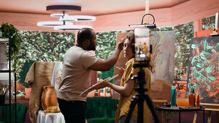 Artists recording creative process of painting an artwork piece, hosting online art class for...