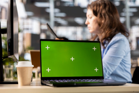 Focused administrator solving tasks at the office next to copy space display, using data analytics...