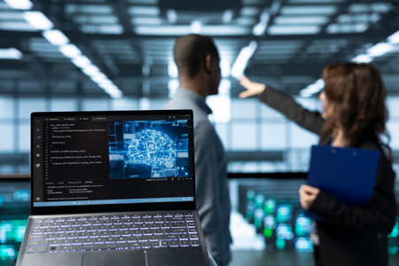 Laptop in front of data center technicians in blurry background deploying AI driven management...