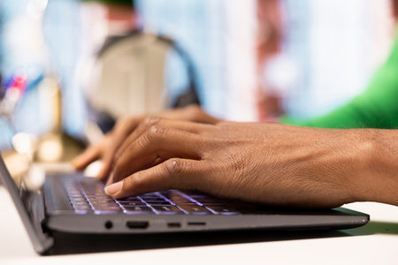 Worker at home office desk editing documents on notebook, updating reports and files, typing text....