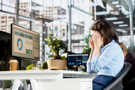 Unwell tired employee deals with a severe headache at the workstation, feeling sick and overworked...