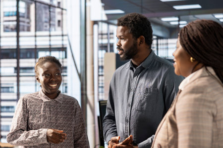 Team of black professionals collaborating on a new expansion project, focusing on company growth and strategic planning. Shareholder and office staff ensures effective use of resources.の写真素材