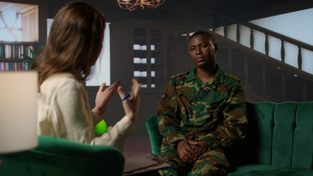 Psychotherapy session for an armed forces veteran in distress and grief, showcasing therapy for PTSD, trauma and reintegration after combat. Soldier dealing with war flashbacks. Camera A.の写真素材