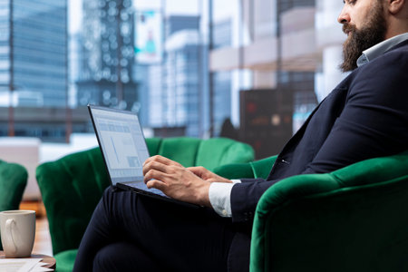 Goal oriented businessman in a high end corporate office plans a strategy to ensure company future,...