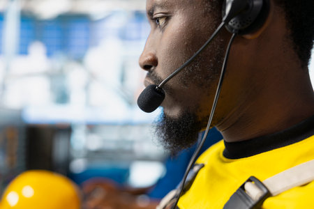 Solar energy male supervisor offering remote support in high tech factory, working in customer...