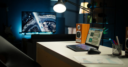 Cozy loft style illuminated apartment with a modern home office. The space features wooden furniture, decorative plants and a TV combining stylish interior design with functional workspace.の写真素材