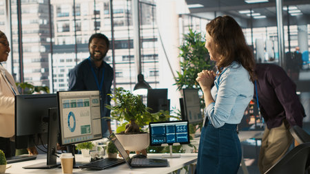 Multiethnic coworkers in office celebrating achievement, expressing excitement, doing high five....