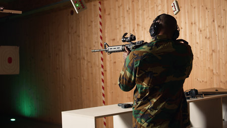 Portrait of military personnel using tactical operations equipment, shooting assault rifle. Smiling...