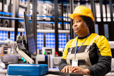 Automated factory engineer analyzes production line using digital interface. The smart manufacturing...