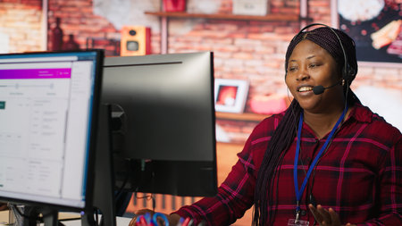Call center worker tracking shipments at work, looking at computer screen, handling delivery delays....
