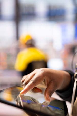 Smart factory engineer developing robotic machinery with CAD software on tablet. Closeup of...