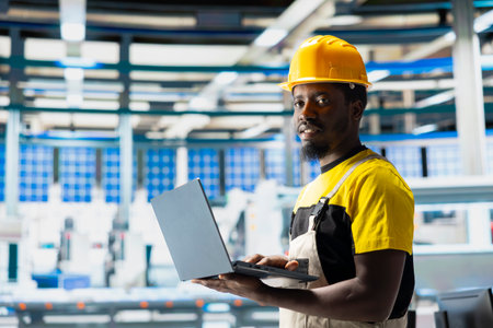 Man engineer in photovoltaics factory uses tracking software on pc to diagnose malfunctioning...