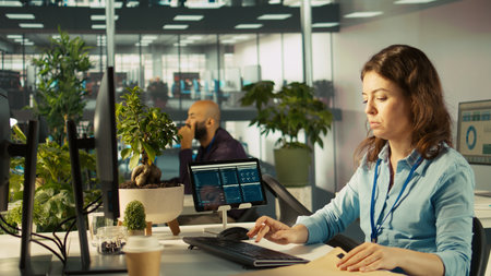 Office clerk at computer desk reading documentation files, solving tasks. Staff member analyzing...