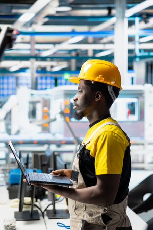 Engineer reviews solar panel renewable energy configurations in facility, working on the production...