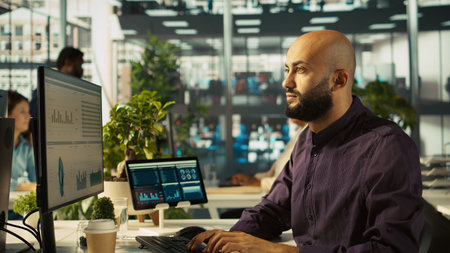 Startup staff member working to hit key performance targets for revenue, profitability and...