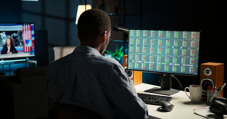 Male investor following stock exchange live trends on home computer, risking funds to increase...