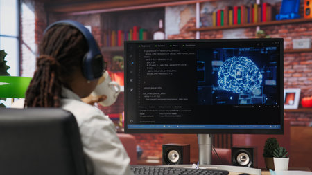 Software developer wearing headphones using computer at home for artificial intelligence computing simulating human brain. IT expert listening music and working with AI deep neural networks, camera Bの写真素材