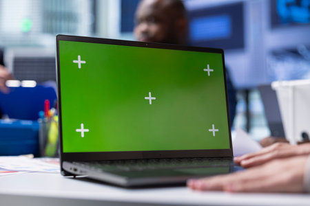 Factory expert researches new photovoltaics materials on chroma key notebook, close up. Solar panel plant specialist using green screen laptop, developing new solar energy systems prototypesの写真素材