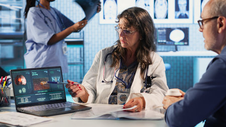 Female radiologist examines a tumor scan with male patient, providing medical diagnosis and...
